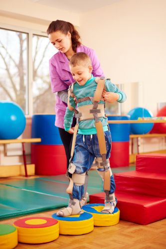 Child with cerebral palsy in physical therapy