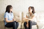 Female patient talking to therapist on sofa